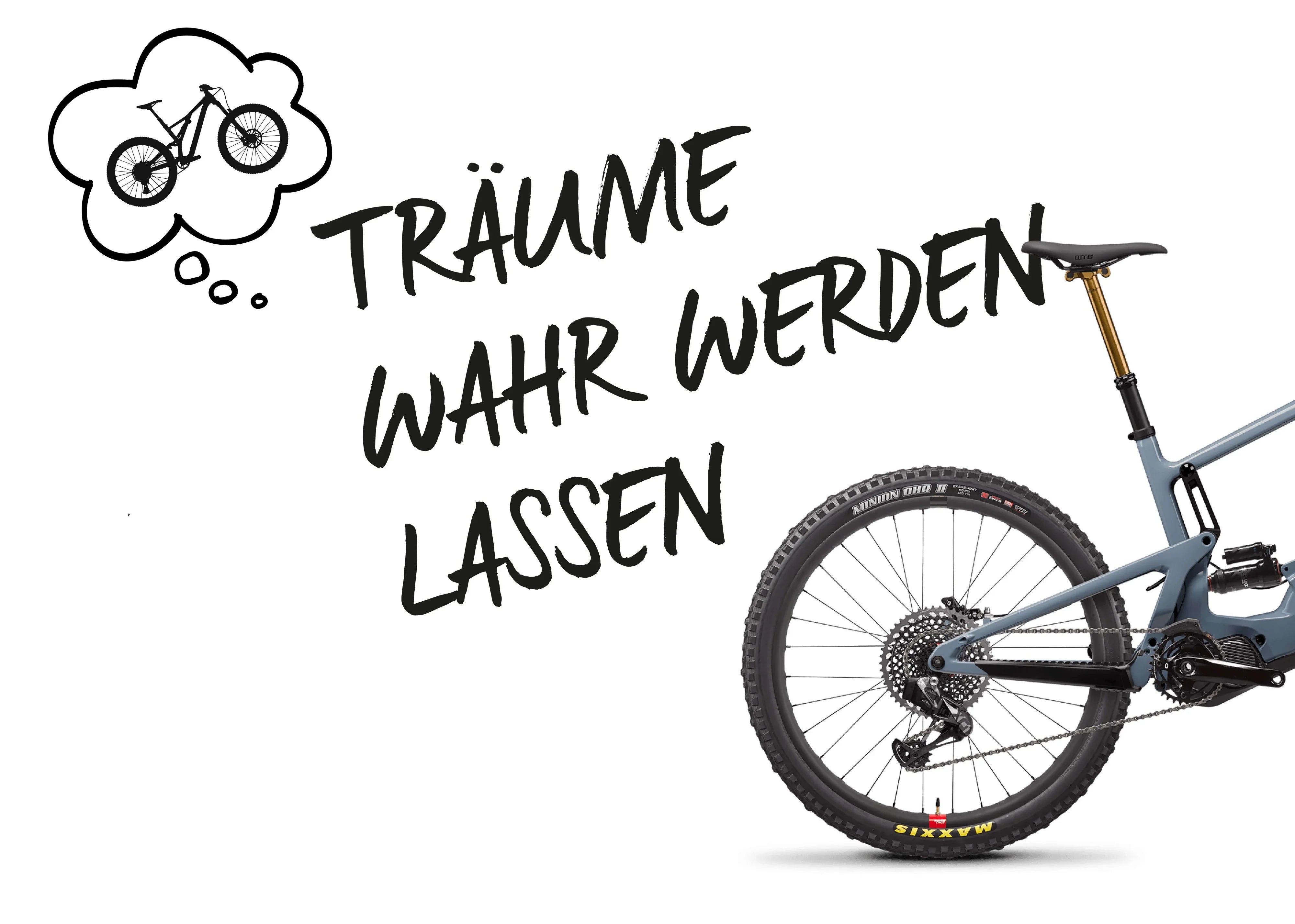 Teilansicht eines blauen Mountainbikes mit Hinterrad, Federgabel und Kettenschaltung, Text "Träume wahr werden lassen".